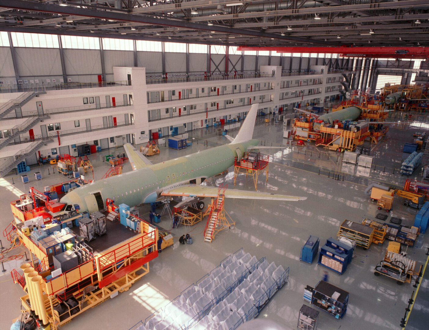 A large hangar with many planes in it